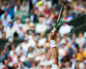 Player serving during a match at Wimbledon 2016