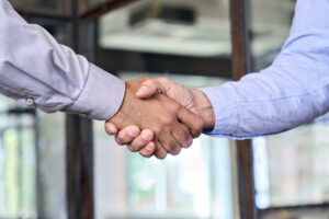 Two businessmen shake hands with business handshake concept.